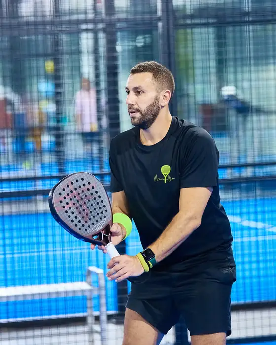 Players mid-rally on an indoor court at Padel Art