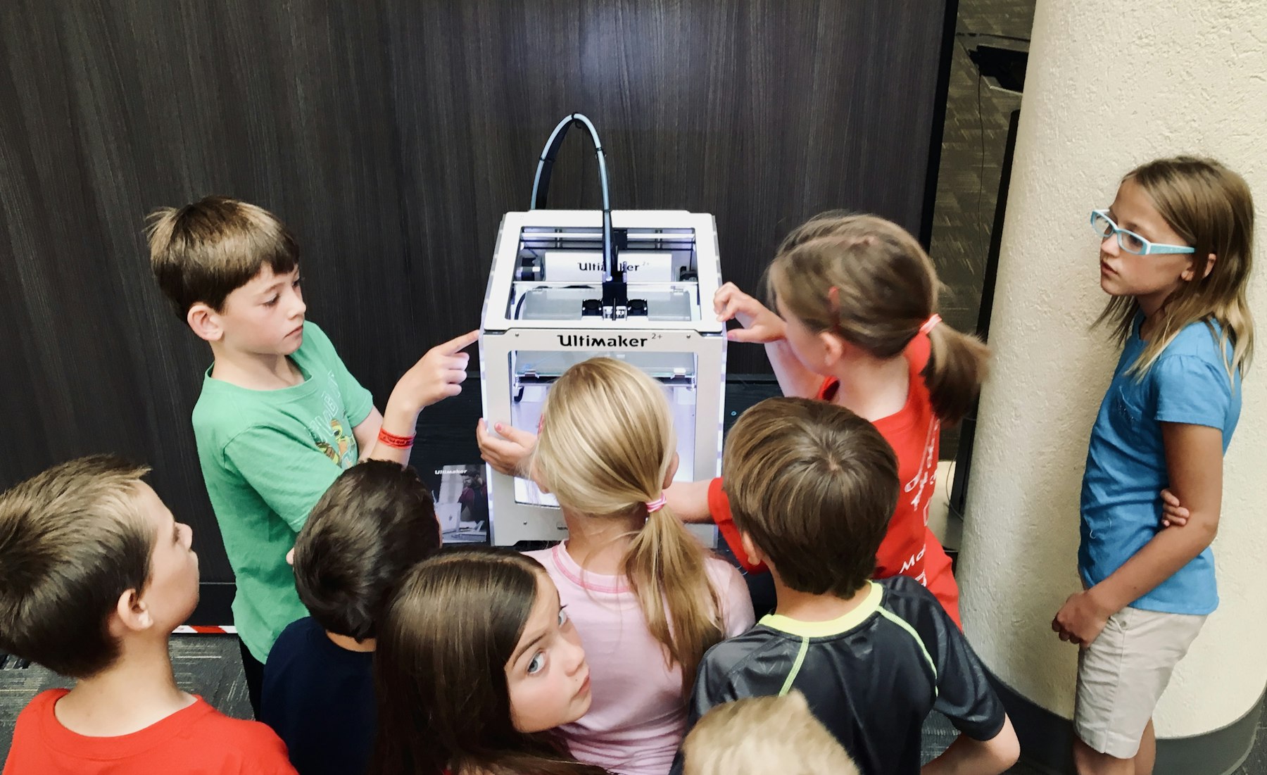 Children working on a robotics kit together at a table