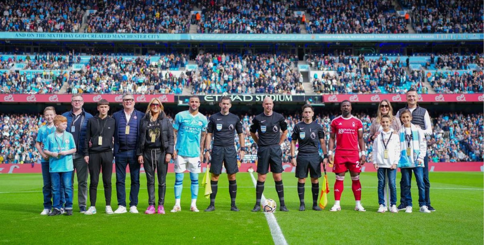 Manchester City matchday: guests on the Etihad Stadium centre circle with the captain and match officials