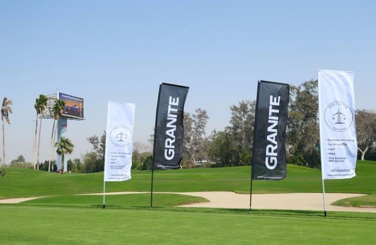 Sponsor flags beside the fairway at a WPSL golf event
